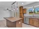 Bright kitchen featuring a wooden island, stainless steel appliances, and charming pendant lighting at 527 N Lesueur --, Mesa, AZ 85203