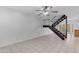 Bright living room with tile flooring, modern staircase, and a ceiling fan at 527 N Lesueur --, Mesa, AZ 85203