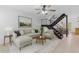 Open living room showcasing staircase, neutral furniture, and large painting at 527 N Lesueur --, Mesa, AZ 85203