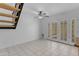 Bright room with white tile floors, glass doors, and modern staircase at 527 N Lesueur --, Mesa, AZ 85203