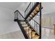 Modern staircase featuring wooden stairs, black rails and ceiling fan with lights at 527 N Lesueur --, Mesa, AZ 85203