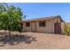 Charming single-story home with mature trees, rock landscaping, and a private gated courtyard at 538 E Estevan Ave, Apache Junction, AZ 85119