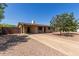 Inviting single-story home with a covered porch, a long driveway, and a low-maintenance desert landscape at 538 E Estevan Ave, Apache Junction, AZ 85119