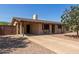 Inviting single-story home with a covered porch, a long driveway, and a low-maintenance desert landscape at 538 E Estevan Ave, Apache Junction, AZ 85119
