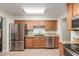 Kitchen features stainless steel appliances and bright, under-cabinet lighting at 538 E Estevan Ave, Apache Junction, AZ 85119