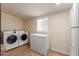 Functional laundry room with a washer, dryer, freezer and tile flooring at 538 E Estevan Ave, Apache Junction, AZ 85119