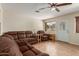 Spacious living room features tile floors and a comfortable brown sofa at 538 E Estevan Ave, Apache Junction, AZ 85119