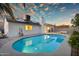 Lush backyard showcasing a sparkling pool, solar panels, and patio area, ideal for enjoying the outdoors at 6201 E Waltann Ln, Scottsdale, AZ 85254