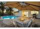 Inviting backyard with a pristine pool, patio furniture, and shaded lounge area, perfect for outdoor relaxation and entertaining at 6201 E Waltann Ln, Scottsdale, AZ 85254