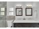 Elegant bathroom with a double sink vanity, tiled walls, and a glass shower door at 6201 E Waltann Ln, Scottsdale, AZ 85254