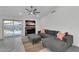 Comfortable living room featuring stylish gray sectional sofa, modern fireplace, and natural light from sliding glass doors at 6201 E Waltann Ln, Scottsdale, AZ 85254