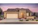 Charming single-story home with a desert landscape, two car garage, and a tile roof at 7661 W Meadowlark Way, Florence, AZ 85132