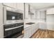Modern kitchen with stainless steel oven and microwave, light gray cabinets, and quartz countertops at 7661 W Meadowlark Way, Florence, AZ 85132