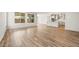 Open-concept living space showcasing wood-look floors connecting the living area to the modern kitchen at 7661 W Meadowlark Way, Florence, AZ 85132