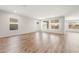 Expansive living area featuring wood-look floors and multiple windows for ample natural light at 7661 W Meadowlark Way, Florence, AZ 85132
