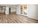 Spacious living area featuring wood-look floors and an open layout to the kitchen at 7661 W Meadowlark Way, Florence, AZ 85132