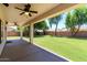 Large, open backyard featuring a covered patio and well-maintained lawn, perfect for entertaining at 1125 E San Carlos Way, Chandler, AZ 85249