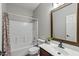 Bathroom features a shower over tub, toilet, vanity, and large framed mirror at 1125 E San Carlos Way, Chandler, AZ 85249