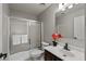 Updated bathroom featuring a shower-tub combo with glass doors, and a modern vanity at 1125 E San Carlos Way, Chandler, AZ 85249