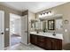 Bathroom with a dual vanity and a view of the walk-in shower, toilet and doorway to bedroom at 1125 E San Carlos Way, Chandler, AZ 85249