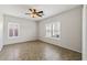 Light-filled bedroom with tile flooring, ceiling fan, and plantation shutters at 1125 E San Carlos Way, Chandler, AZ 85249