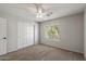 Neutral-toned bedroom with carpet, a ceiling fan, closet and window with shuttered blinds at 1125 E San Carlos Way, Chandler, AZ 85249