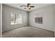 Cozy carpeted bedroom featuring a ceiling fan and plantation shutters at 1125 E San Carlos Way, Chandler, AZ 85249