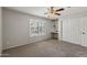 Comfortable bedroom with carpet, a ceiling fan, and a window with plantation shutters and a built-in desk at 1125 E San Carlos Way, Chandler, AZ 85249