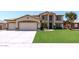 Charming two-story home featuring a well-manicured lawn and a spacious three-car garage at 1125 E San Carlos Way, Chandler, AZ 85249