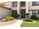 Beautifully landscaped front entrance with mature plantings and a decorative security screen door at 1125 E San Carlos Way, Chandler, AZ 85249