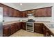 Spacious kitchen featuring dark wood cabinetry and stainless steel double oven at 1125 E San Carlos Way, Chandler, AZ 85249