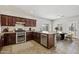 Kitchen with dark cabinetry, stainless steel appliances, and an adjacent breakfast nook at 1125 E San Carlos Way, Chandler, AZ 85249