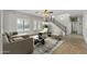 Bright living room with plantation shutters and staircase at 1125 E San Carlos Way, Chandler, AZ 85249