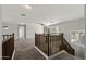Second floor loft space with neutral walls and carpets, railing and open floor plan at 1125 E San Carlos Way, Chandler, AZ 85249