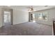 An open loft area featuring neutral carpeting, sliding glass doors, and a ceiling fan at 1125 E San Carlos Way, Chandler, AZ 85249