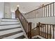 Staircase with wooden banister connects the first and second floors of the home at 1125 E San Carlos Way, Chandler, AZ 85249