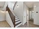 Staircase with dark wood banister leading to the upper level and bathroom at 1125 E San Carlos Way, Chandler, AZ 85249