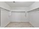 Spacious walk-in closet with tile floor, hanging rods, and white walls offer lots of storage space at 1125 E San Carlos Way, Chandler, AZ 85249