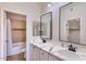 Bathroom featuring double sinks, marble countertops, and decorative tile work in the shower at 11333 N 92Nd St # 1118, Scottsdale, AZ 85260