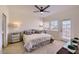 Bedroom with neutral decor, ceiling fan, and side tables, featuring a doorway to the patio at 11333 N 92Nd St # 1118, Scottsdale, AZ 85260