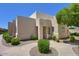 Exterior view of a tan home with well-manicured landscaping and a blue sky at 11333 N 92Nd St # 1118, Scottsdale, AZ 85260