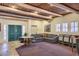 Elegant living room with wooden beamed ceiling, stone floors, and comfortable seating arrangement at 11333 N 92Nd St # 1118, Scottsdale, AZ 85260