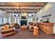 Community lounge with comfortable seating, fireplace, television, and Mission de los Arroyos signage at 11333 N 92Nd St # 1118, Scottsdale, AZ 85260