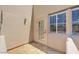 Covered patio area with a doorway and window on stucco wall with natural sunlight at 11333 N 92Nd St # 1118, Scottsdale, AZ 85260