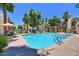 Resort-style pool and hot tub with palm trees, lounge chairs, and umbrellas for relaxing in the sun at 11333 N 92Nd St # 1118, Scottsdale, AZ 85260