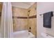 Tiled shower with decorative accent tiles and shower curtain, featuring a bathtub at 11333 N 92Nd St # 1118, Scottsdale, AZ 85260