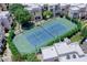 Aerial view of the community tennis court, surrounded by lush landscaping and neighborhood buildings at 11333 N 92Nd St # 1118, Scottsdale, AZ 85260