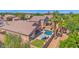 Aerial view of the property displaying a backyard pool, green lawn, patio and neat landscaping at 1144 E Nunneley Rd, Gilbert, AZ 85296
