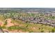 Aerial view captures a golf course community with tree-lined fairways, houses, ponds and blue skies at 1144 E Nunneley Rd, Gilbert, AZ 85296