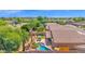 An aerial shot displays the backyard with pool, patio area, and lush landscaping in this desert neighborhood at 1144 E Nunneley Rd, Gilbert, AZ 85296